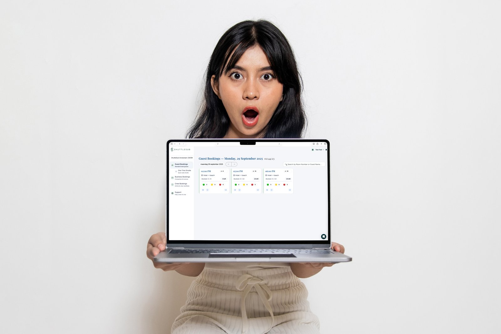 Front-desk staff holding the ShuttleSub dashboard